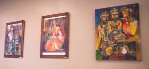 A wall adorned with various paintings.